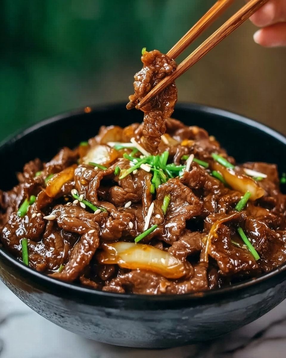 A close-up view of a black bowl filled with tender slices of cooked beef coated in a glossy brown sauce, mixed with soft, translucent light yellow onion slices and small green chive pieces scattered on top. A pair of chopsticks held by a woman's hand lifts a portion of the meat from the bowl, showcasing the rich, shiny texture of the sauce and the juicy meat. The bowl sits on a white marbled surface, and the background softly blurs into green and brown tones, highlighting the dish's deep colors. Photo taken with an iphone --ar 4:5 --v 7